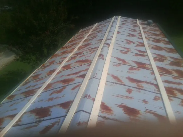 Rusted metal roof panels with new wood purlins before replacement — Storm Damage Roof Repair in Block Island by Roofing Brothers